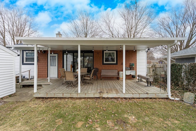 exterior space with a wooden deck, a yard, a chimney, and fence