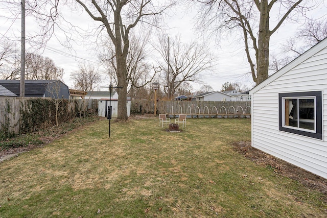 view of yard featuring an outdoor structure and a fenced backyard