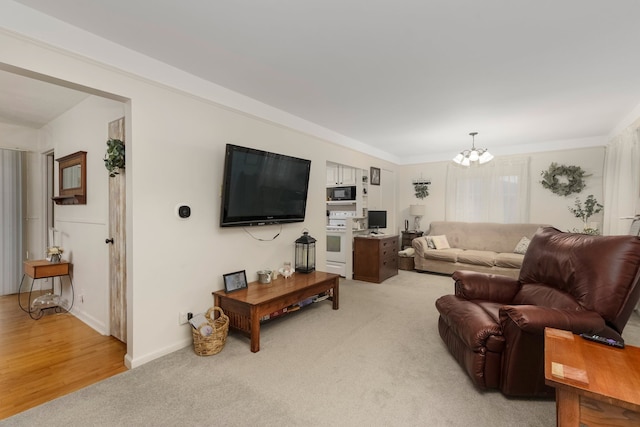 living area with light colored carpet, baseboards, and a notable chandelier