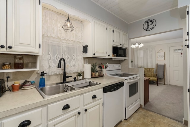 kitchen with a sink, white appliances, ornamental molding, and light countertops