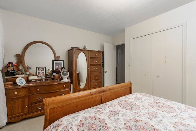 bedroom featuring a closet and light carpet