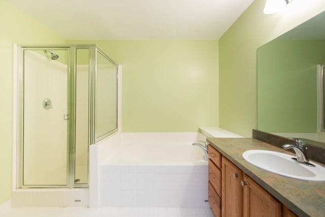 full bathroom featuring vanity, a shower stall, and a bath