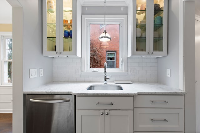 bar with dishwasher, tasteful backsplash, a sink, and pendant lighting