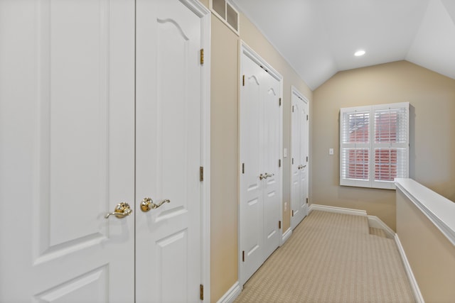 hall featuring baseboards, visible vents, light colored carpet, vaulted ceiling, and recessed lighting