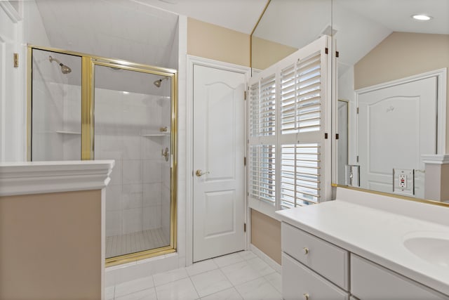 full bath featuring vaulted ceiling, a shower stall, and vanity