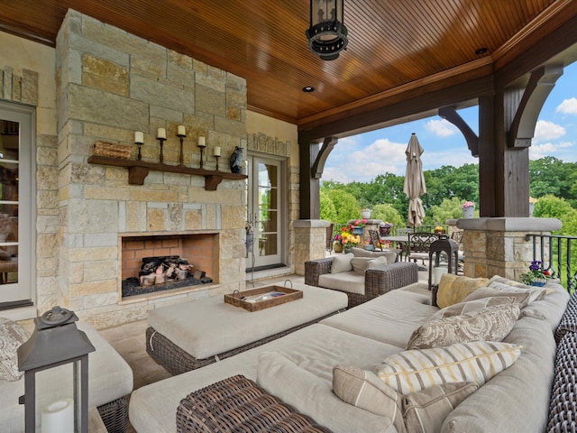 view of patio with an outdoor living space with a fireplace