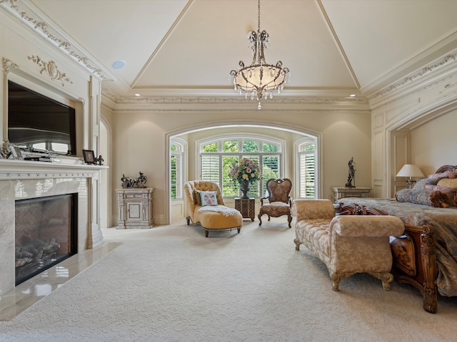 carpeted bedroom featuring high vaulted ceiling, ornamental molding, a high end fireplace, and an inviting chandelier