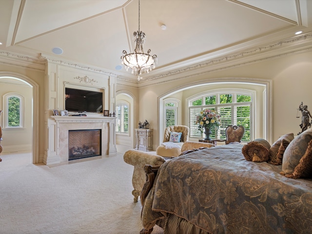 carpeted bedroom featuring a premium fireplace, ornamental molding, a chandelier, and multiple windows