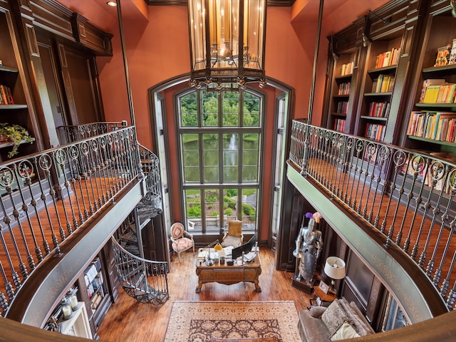 living area featuring wood finished floors and a towering ceiling