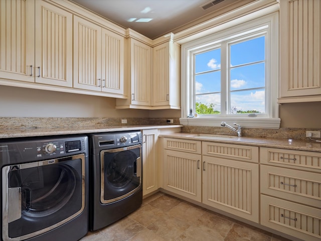 clothes washing area with cabinet space, independent washer and dryer, visible vents, and a sink