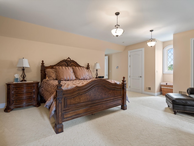 bedroom with light colored carpet and baseboards