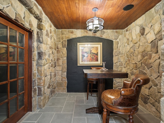 wine cellar with a chandelier and wooden ceiling