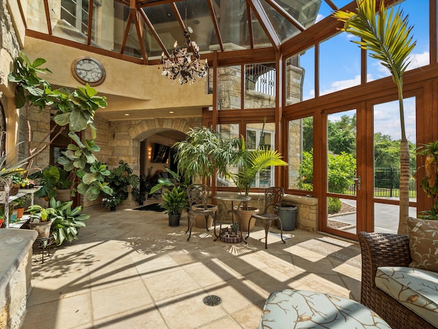 sunroom / solarium with a notable chandelier