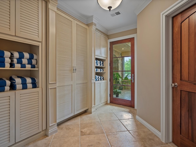 doorway to outside with light tile patterned floors, baseboards, visible vents, ornamental molding, and built in shelves