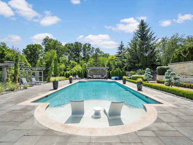 outdoor pool with a pergola and a patio