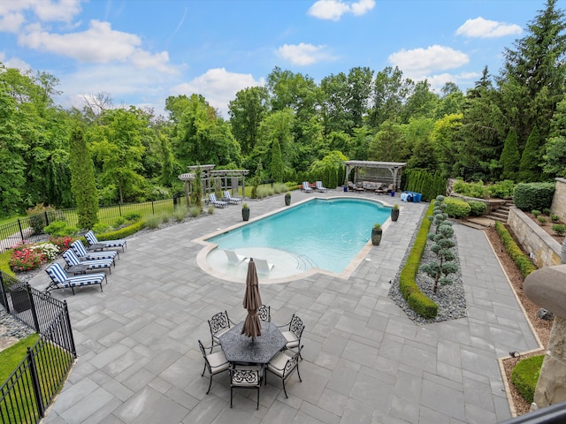 view of pool with a fenced in pool, a patio, fence, outdoor dining area, and a pergola