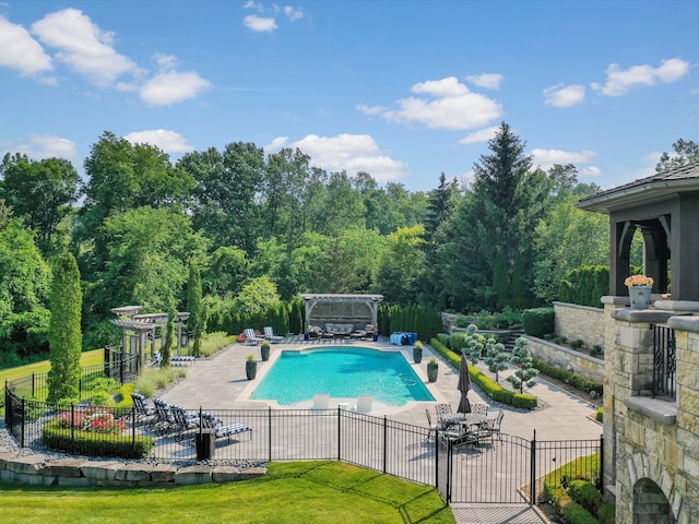 view of swimming pool with a fenced in pool, a lawn, a patio area, fence, and a pergola