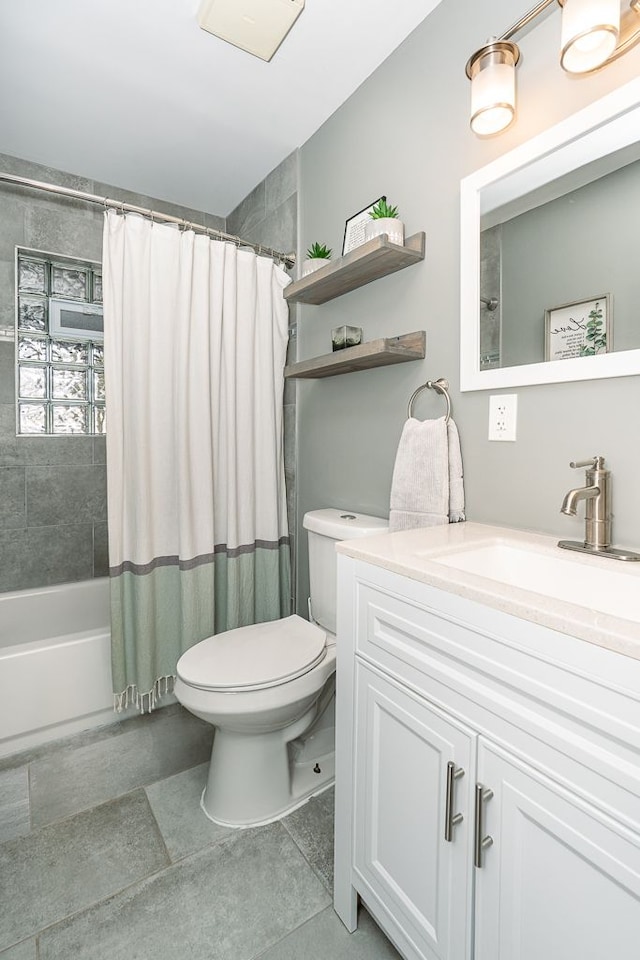 bathroom featuring shower / bath combo, vanity, toilet, and tile patterned floors