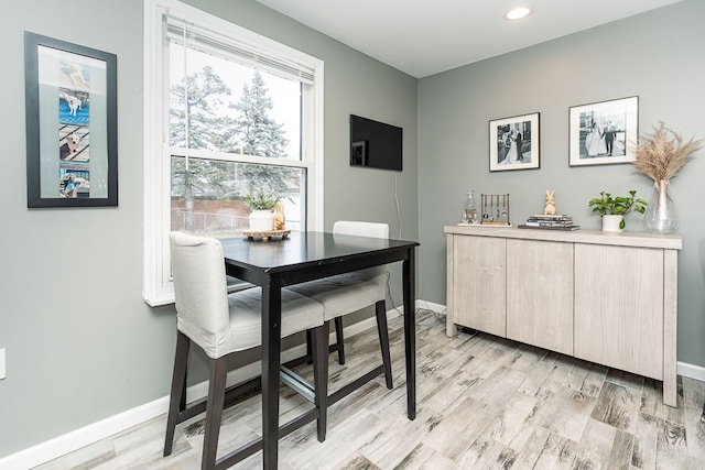 dining space featuring baseboards, recessed lighting, and light wood-style floors