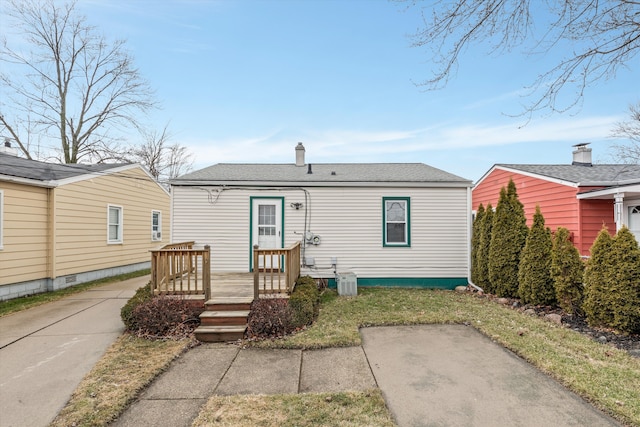 view of front of house with a deck, a shingled roof, and a chimney