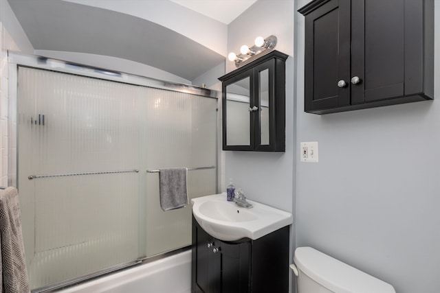 full bathroom with enclosed tub / shower combo, vanity, and toilet