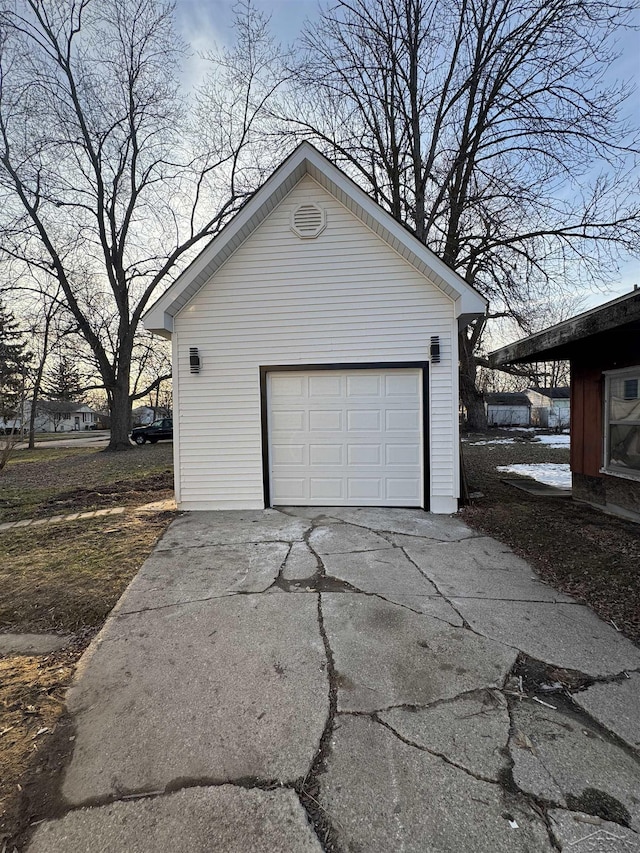 detached garage with concrete driveway