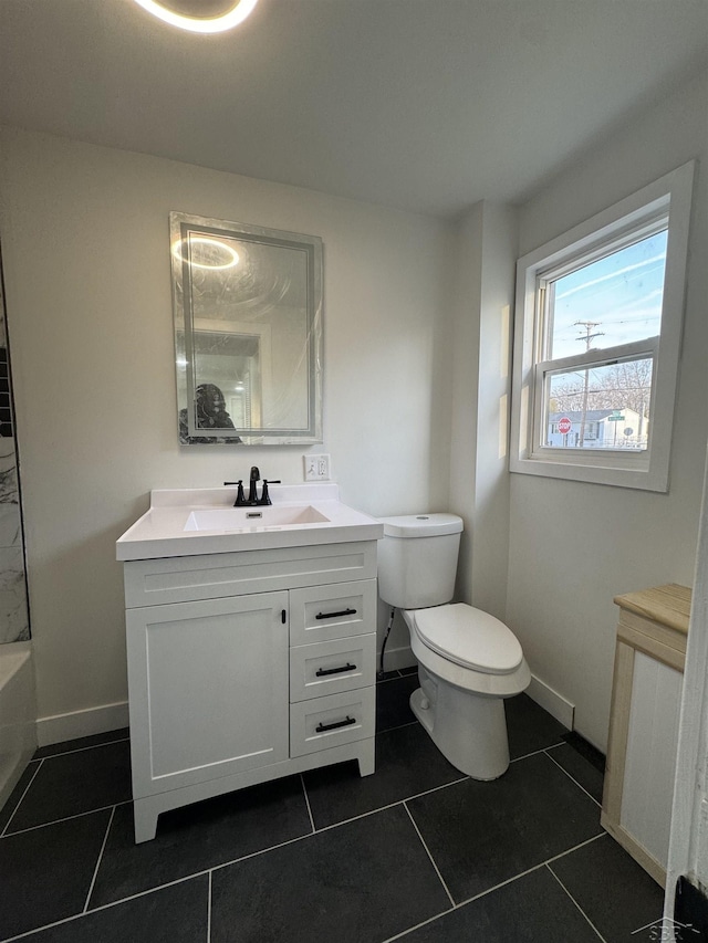 bathroom featuring tile patterned flooring, baseboards, vanity, and toilet