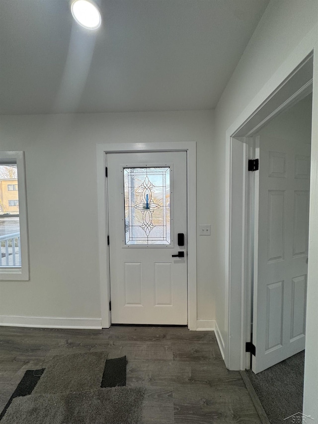 foyer entrance with baseboards, dark wood-type flooring, and a wealth of natural light