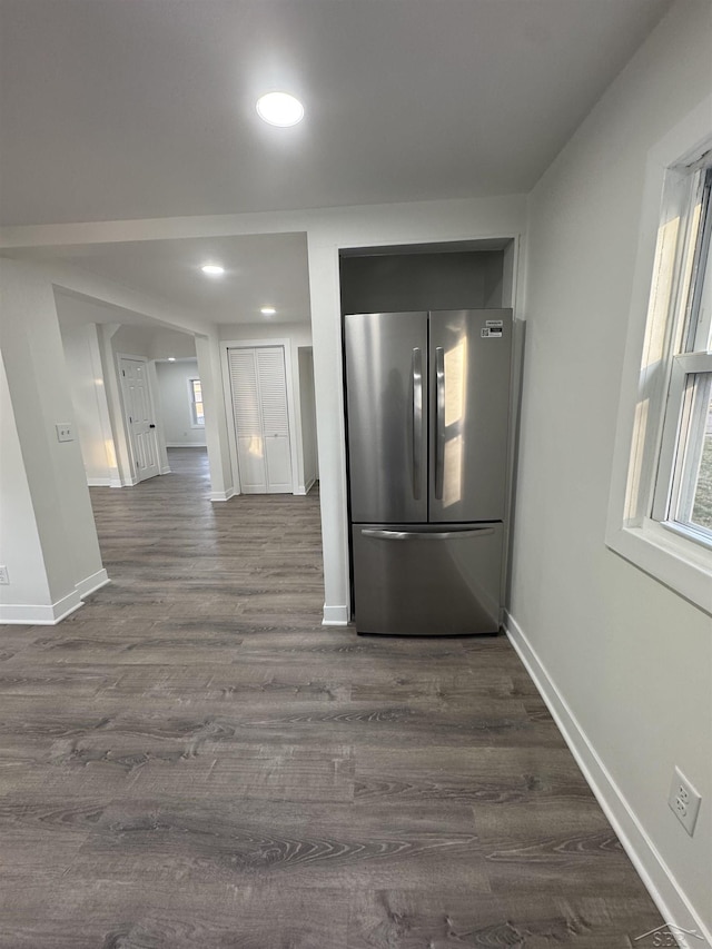 corridor featuring baseboards, dark wood finished floors, and recessed lighting