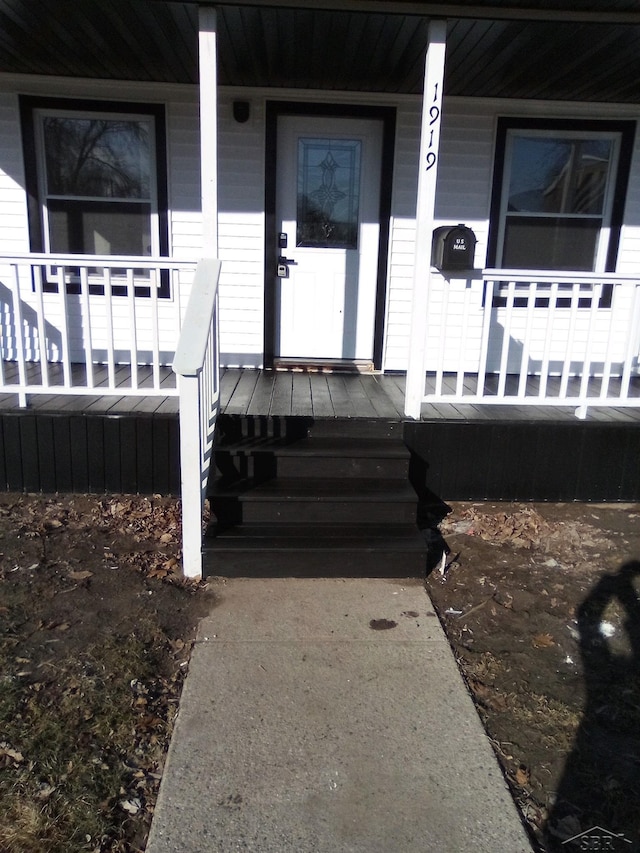 view of exterior entry with a porch