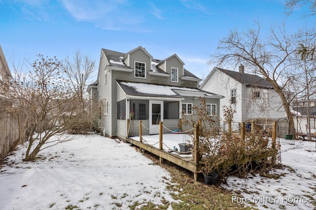 view of snow covered rear of property