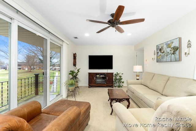 living area with a ceiling fan, recessed lighting, visible vents, and light colored carpet