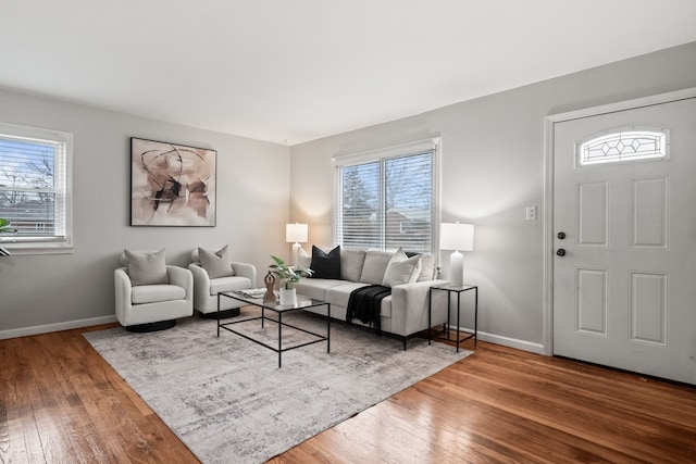 living room featuring hardwood / wood-style flooring and baseboards