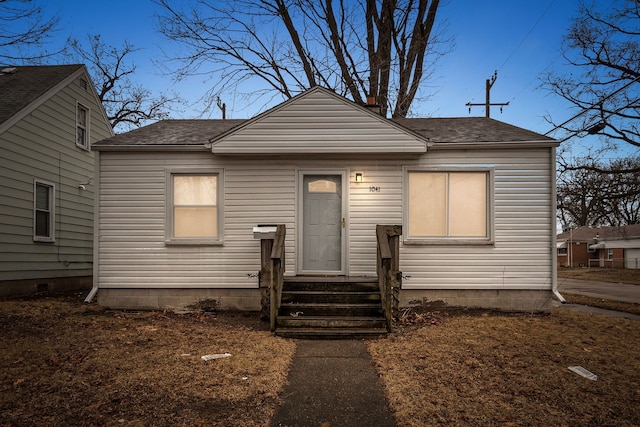 bungalow with a shingled roof and entry steps