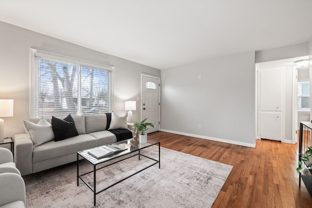 living area with light wood-type flooring and baseboards