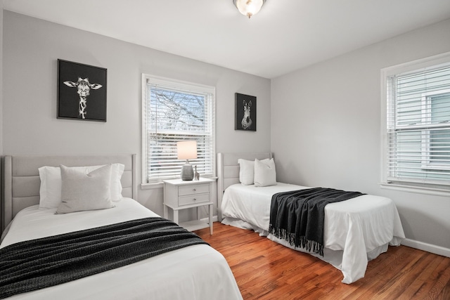 bedroom featuring baseboards and wood finished floors