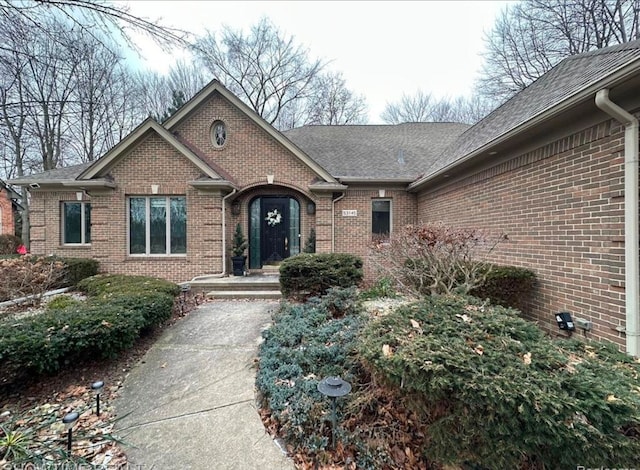 view of exterior entry featuring brick siding