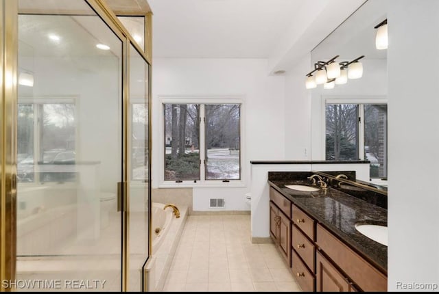 full bathroom with double vanity, visible vents, toilet, tile patterned flooring, and a sink