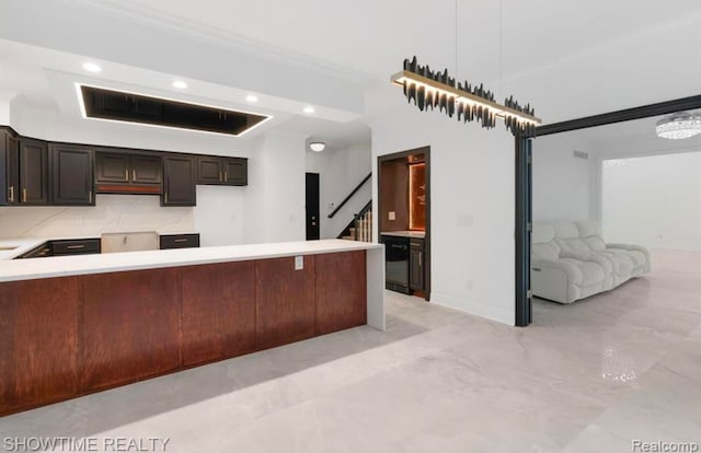 kitchen with marble finish floor, recessed lighting, light countertops, hanging light fixtures, and open floor plan