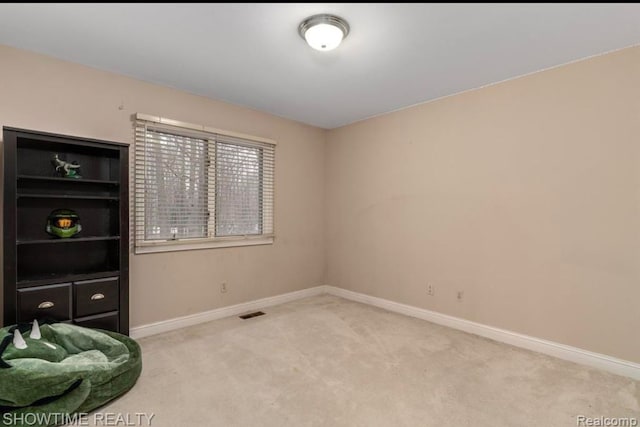 unfurnished room with carpet floors and baseboards