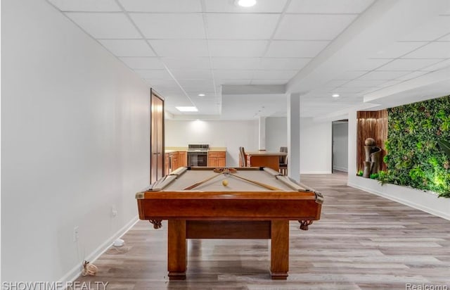 recreation room featuring a paneled ceiling, baseboards, billiards, and light wood finished floors