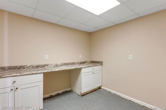 clothes washing area featuring baseboards