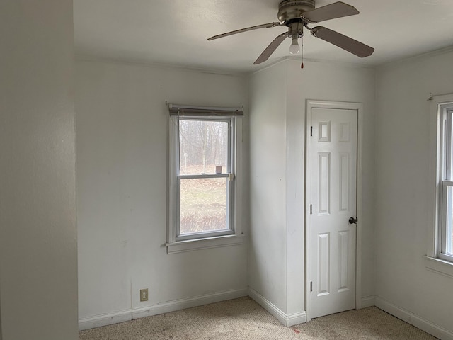 unfurnished bedroom with ceiling fan and baseboards