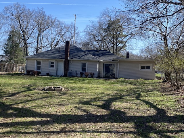 2609 Stanley Ave, Portage, MI 49002 - back of property featuring a chimney, an outdoor fire pit, fence, and a yard
