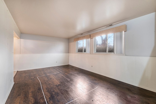 spare room with wood-type flooring and visible vents