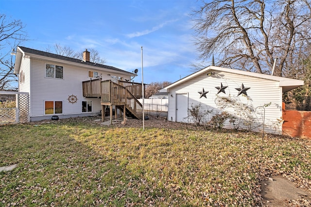 rear view of property with an outbuilding, fence, stairs, a yard, and a wooden deck