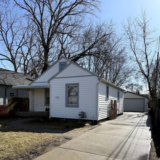 view of front of house featuring a garage, fence, and an outdoor structure