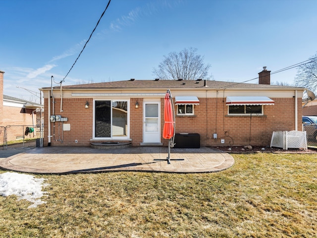 back of house featuring fence, a patio, and brick siding