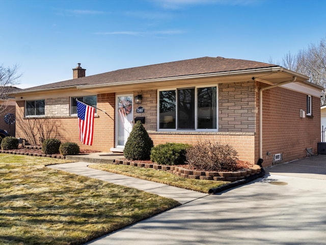 ranch-style home with driveway, a chimney, a front lawn, and brick siding