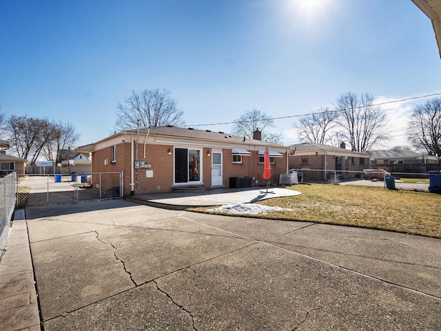 view of front of house with a front yard, fence, and brick siding